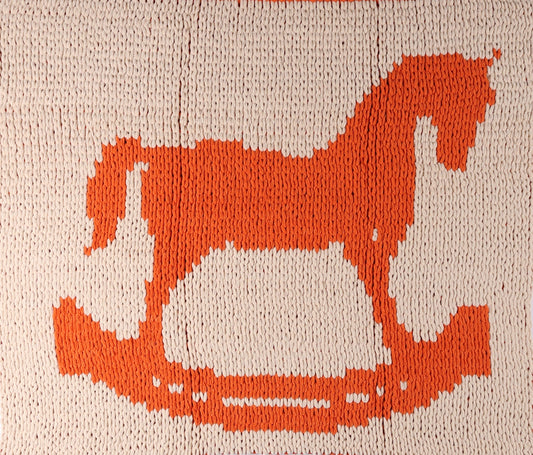 Textile art piece with a geometric pattern on a plain background