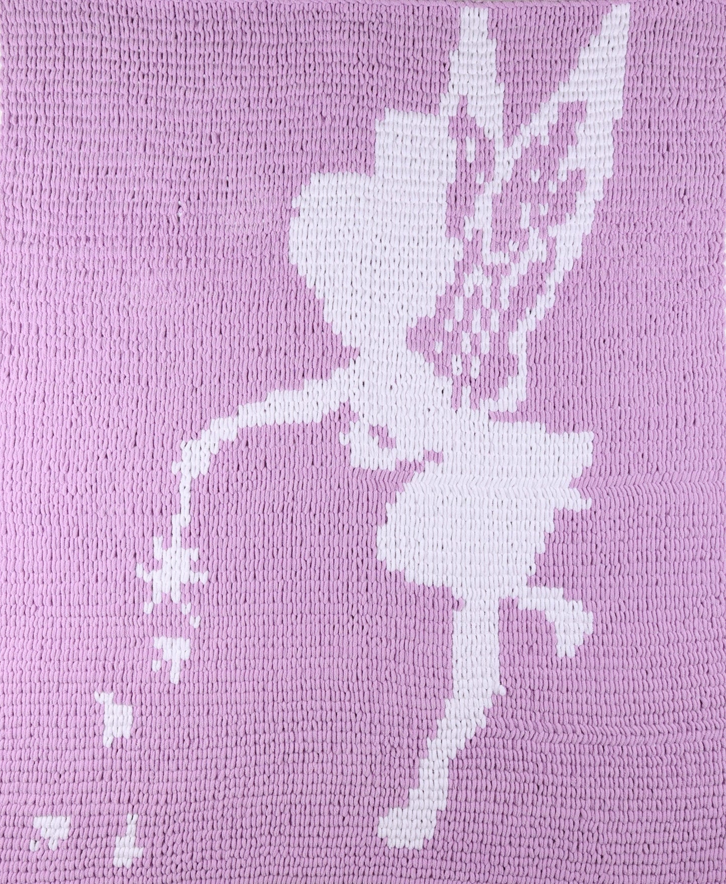 Purple knitted blanket with white tinkle bell design 